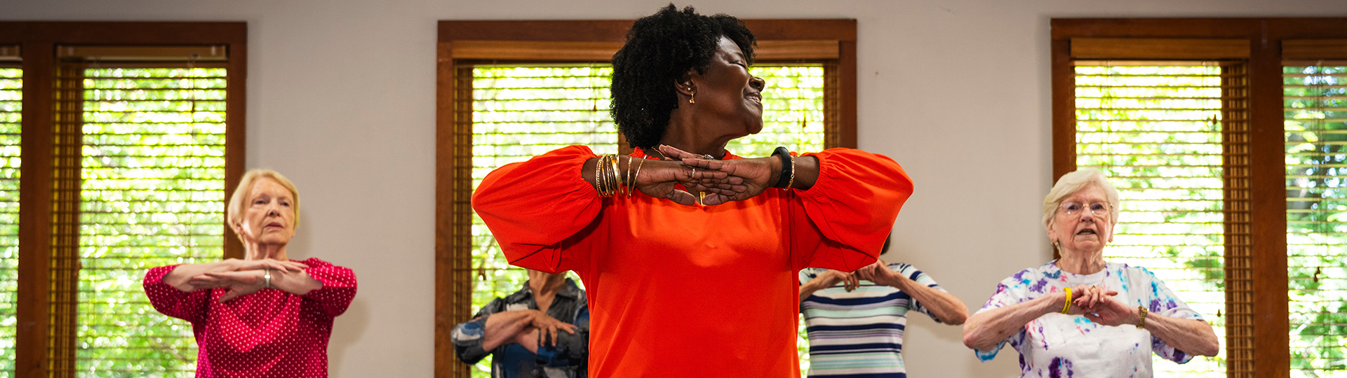 A black senior woman and her friends enjoy yoga at a Georgia senior living community.