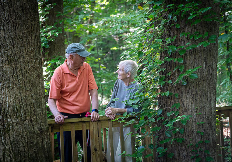 Older couple looking at each other on nature trail | Presbyterian Village Cobb
